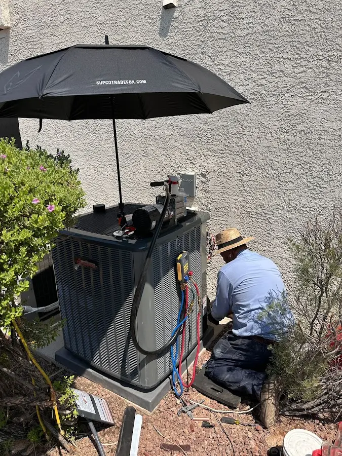 HVAC technician performing outdoor AC maintenance in Dallas